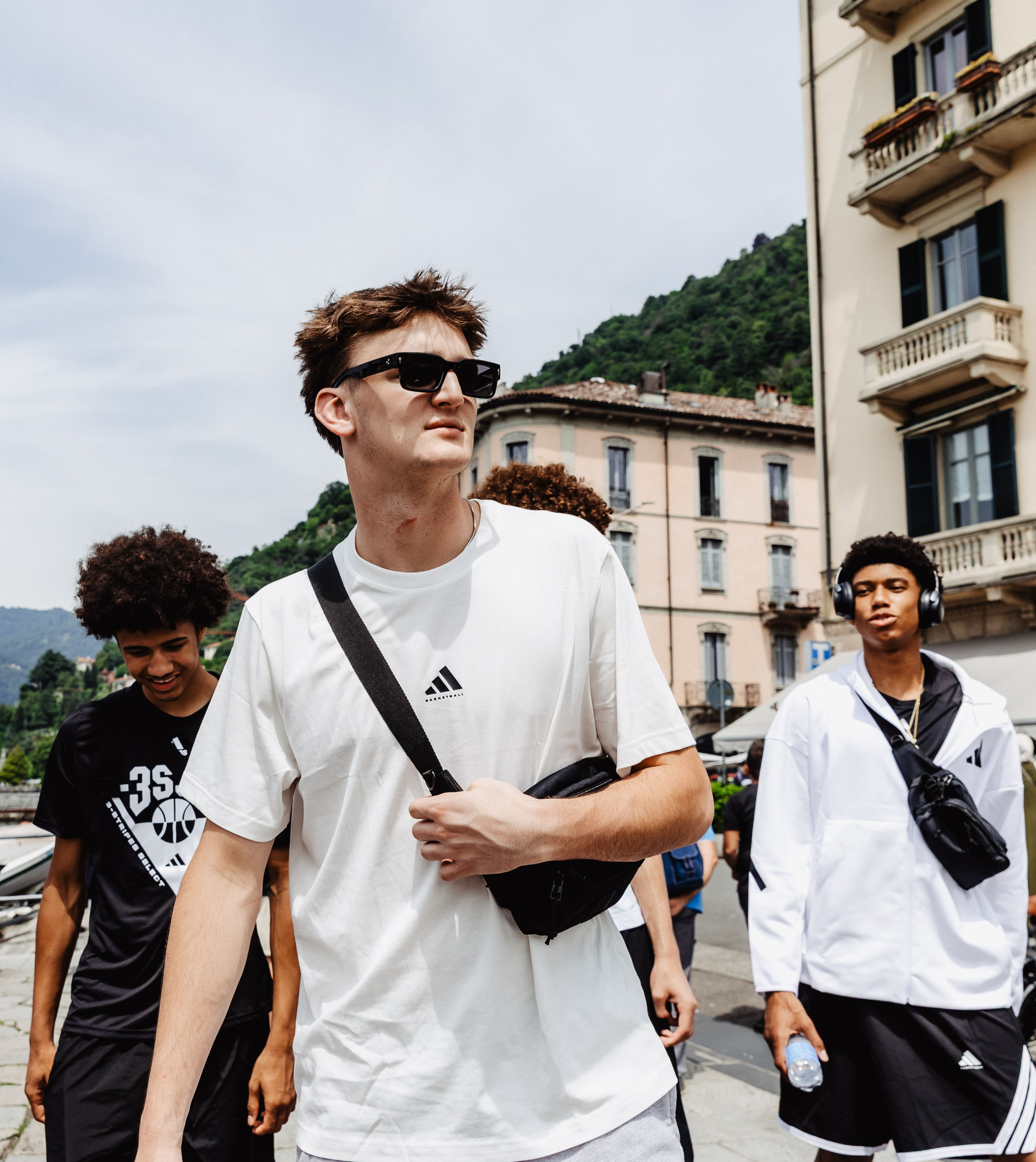 Athletes walking through Lake Como town