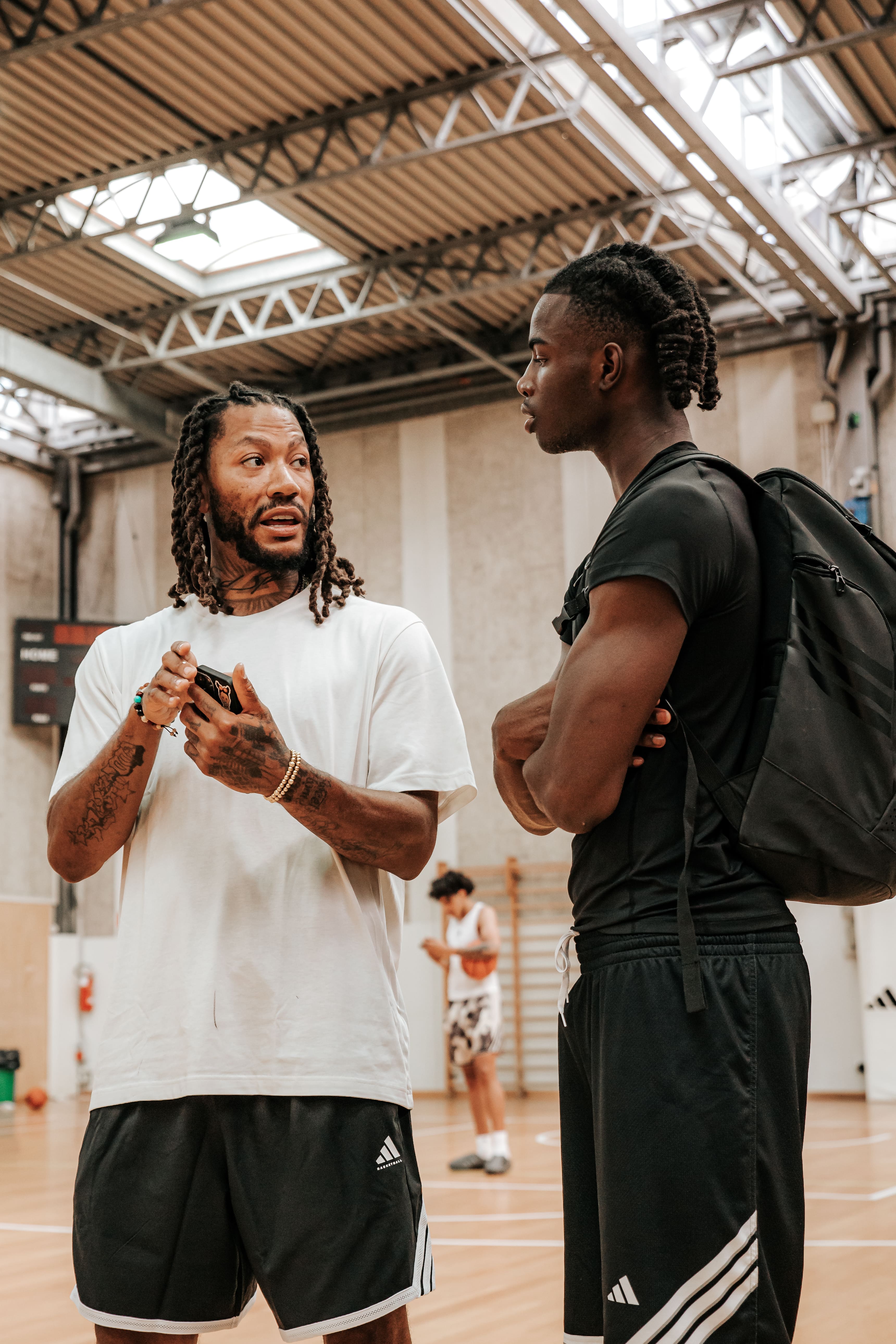 NBA player speaking with a young athlete on a practice court at adidas Eurocamp 2025