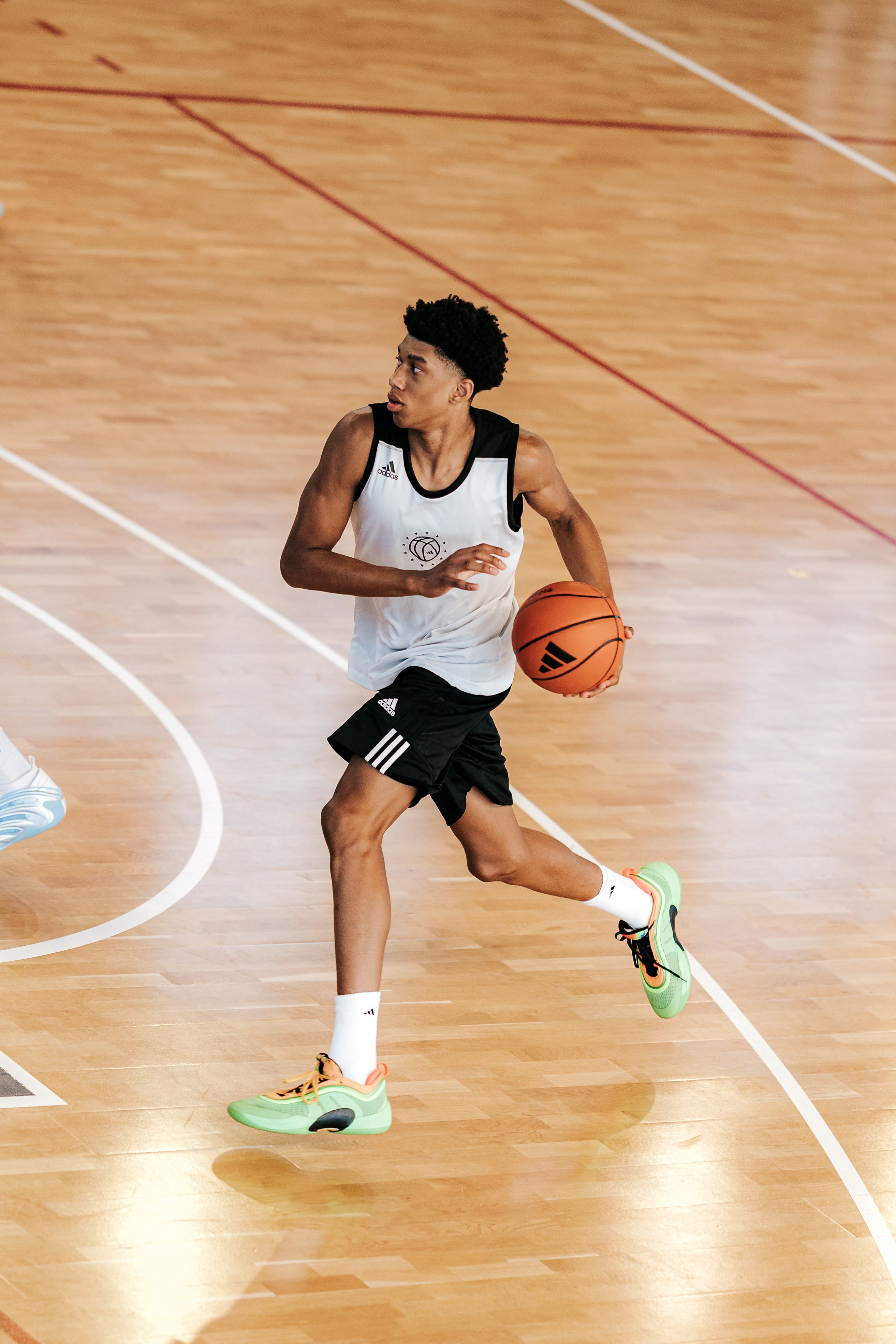 Basketball player dribbling mid-action during a scrimmage at adidas Eurocamp 2025